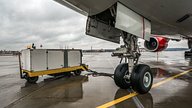 ground support equipment next to airplane landing gear