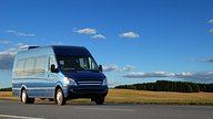 minibus van travelling across countryside