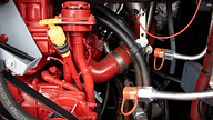 Ardent fire suppression system nozzles pointing at bus engine block