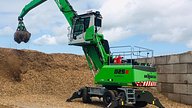 Sennebogen 825E working with wood chippings with ardent tanks in view